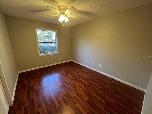 spare room with ceiling fan, dark hardwood / wood-style flooring, and a textured ceiling