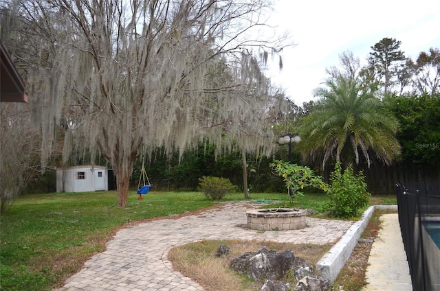 exterior space featuring a shed and an outdoor fire pit