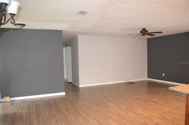 unfurnished room with ceiling fan and hardwood / wood-style flooring