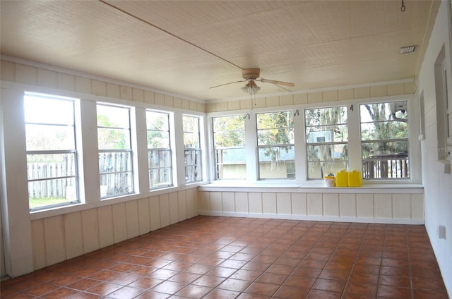 unfurnished sunroom featuring ceiling fan