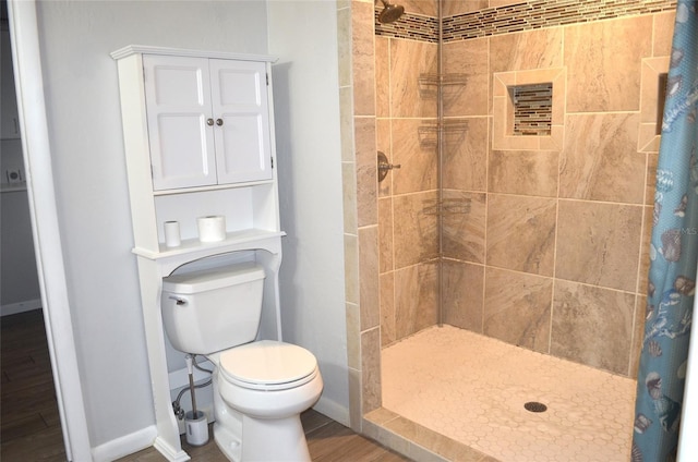 bathroom with toilet and curtained shower