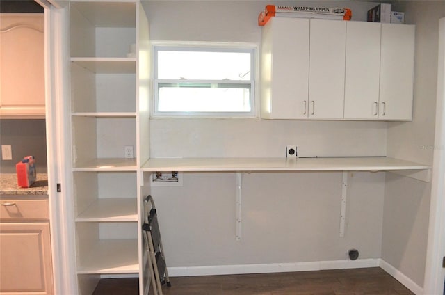 laundry room featuring cabinets, hookup for a washing machine, and dark wood-type flooring