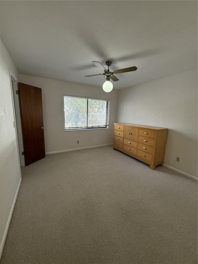 unfurnished bedroom featuring ceiling fan and light colored carpet