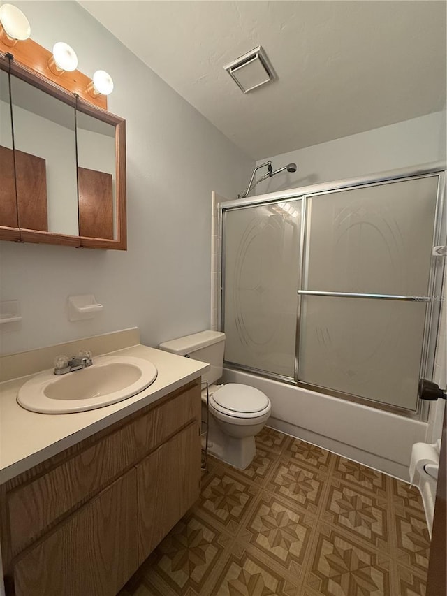 full bathroom with vanity, toilet, and enclosed tub / shower combo