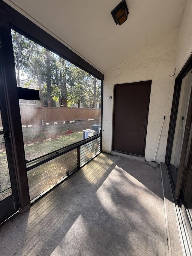 unfurnished sunroom with a wealth of natural light and vaulted ceiling