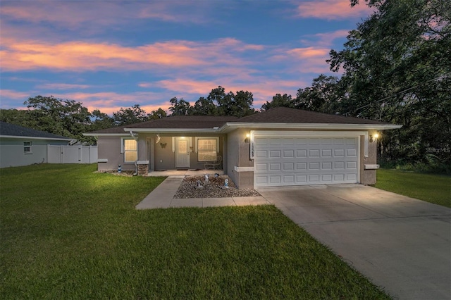 ranch-style home with a lawn and a garage