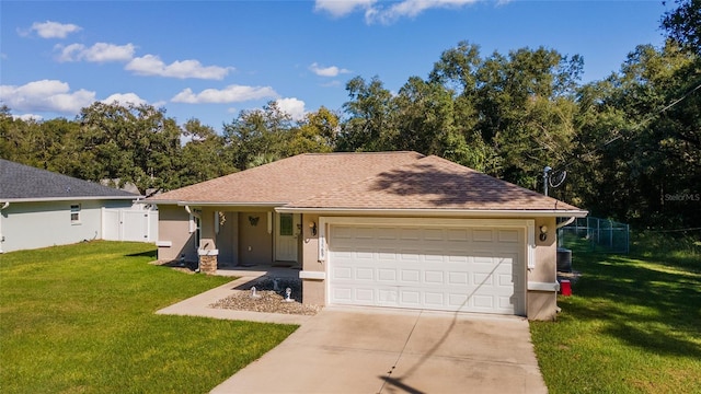 ranch-style house featuring a garage and a front lawn