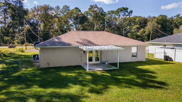 rear view of house featuring a patio area and a yard