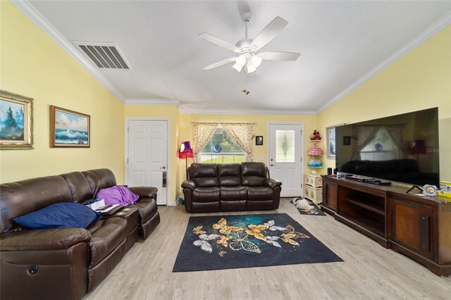 living room with ceiling fan, light hardwood / wood-style flooring, crown molding, and lofted ceiling