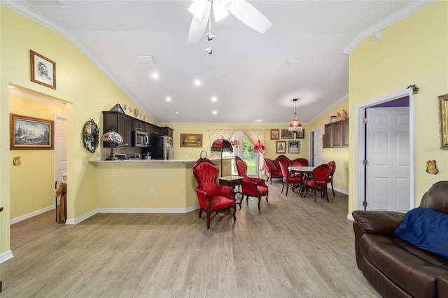 living room featuring ceiling fan, light hardwood / wood-style flooring, vaulted ceiling, and ornamental molding