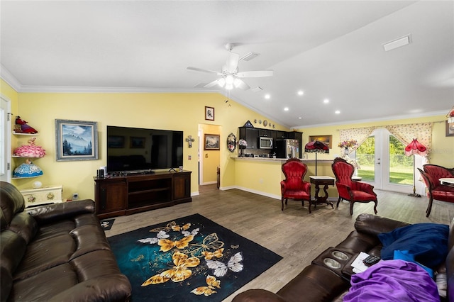 living room with ceiling fan, french doors, crown molding, hardwood / wood-style floors, and lofted ceiling