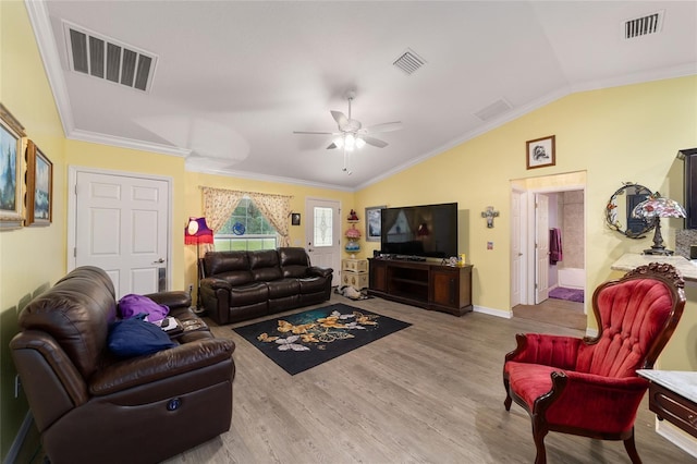 living room featuring ceiling fan, wood-type flooring, vaulted ceiling, and ornamental molding