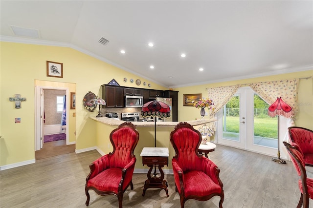 living area featuring light wood-type flooring, lofted ceiling, and crown molding