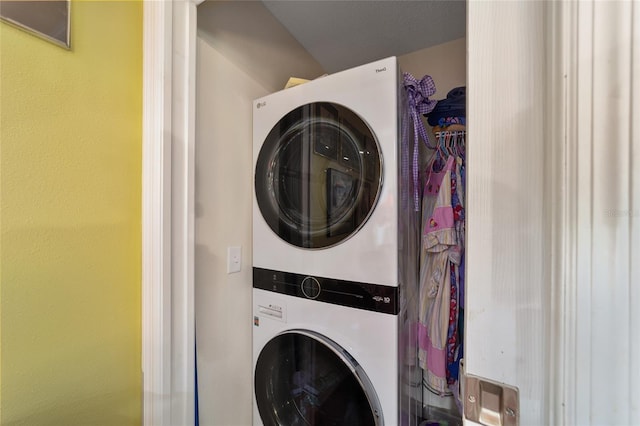 laundry area with stacked washer and clothes dryer