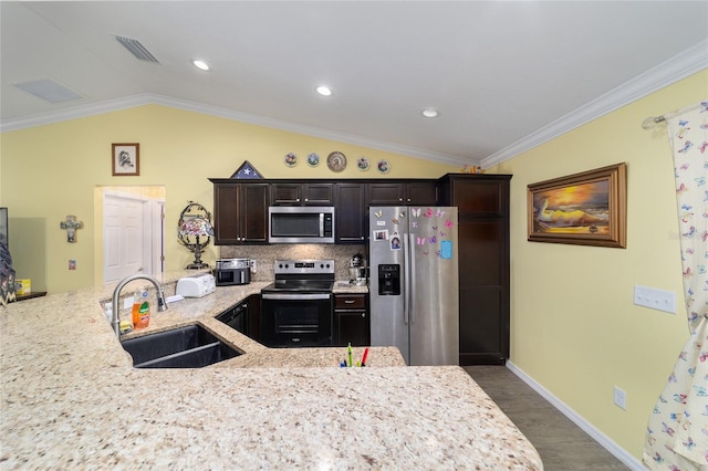 kitchen featuring decorative backsplash, sink, stainless steel appliances, and ornamental molding