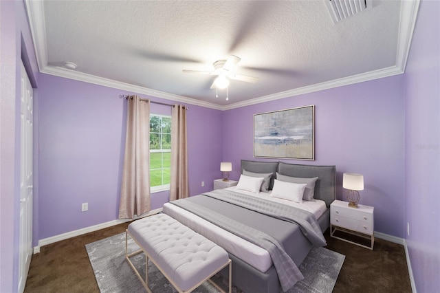 bedroom featuring ceiling fan, dark carpet, ornamental molding, and a textured ceiling