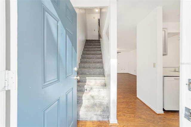 staircase featuring wood finished floors