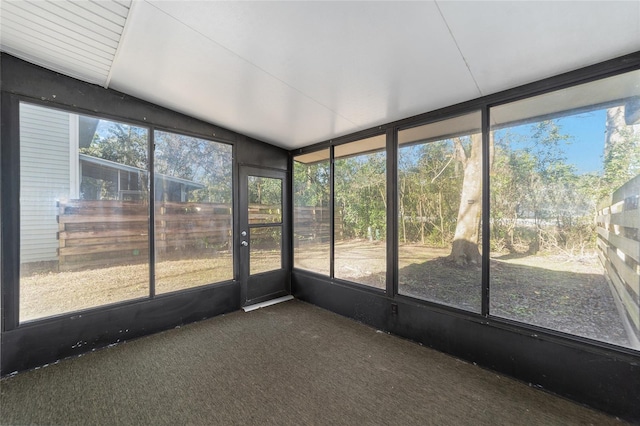 unfurnished sunroom with lofted ceiling