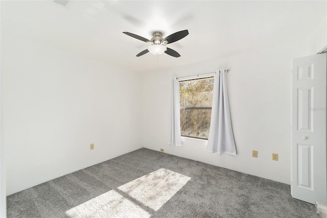 spare room featuring carpet floors and ceiling fan