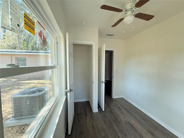 unfurnished bedroom featuring ceiling fan and dark hardwood / wood-style floors