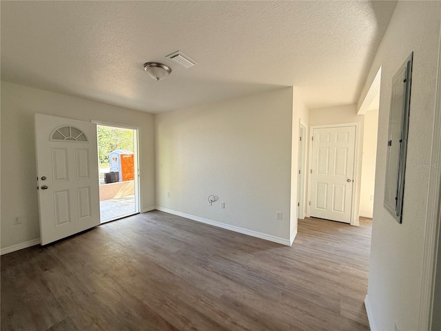 entryway featuring hardwood / wood-style floors and a textured ceiling