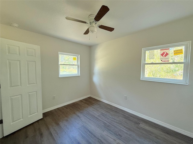 unfurnished bedroom with ceiling fan and dark wood-type flooring