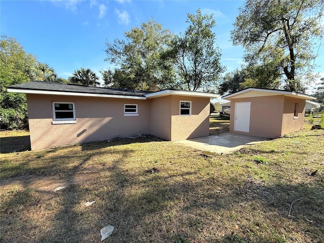 rear view of property with a yard