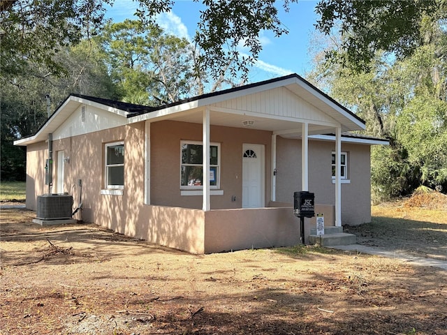 view of front facade with a porch and central air condition unit