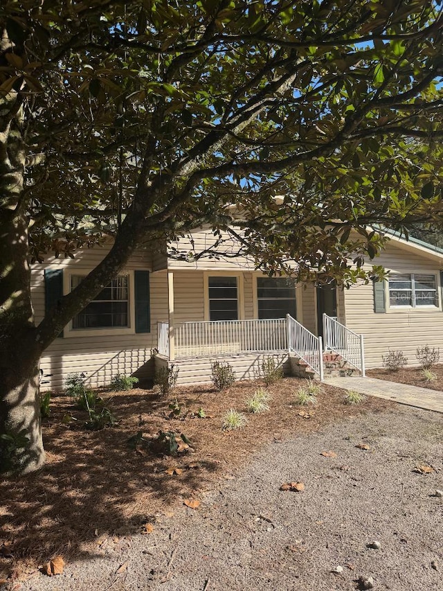 obstructed view of property with covered porch