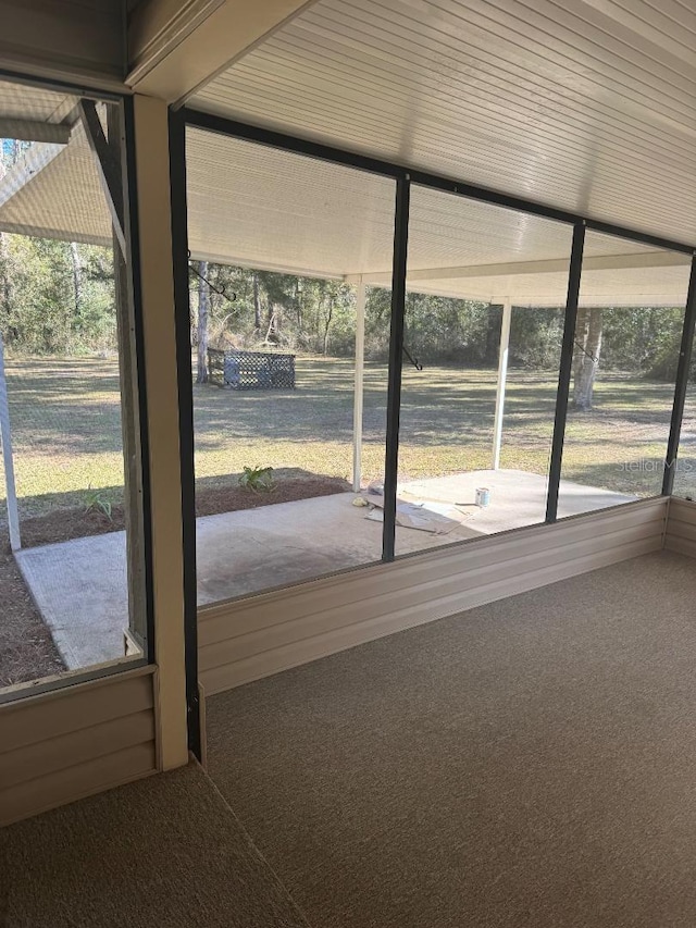 doorway to outside featuring carpet