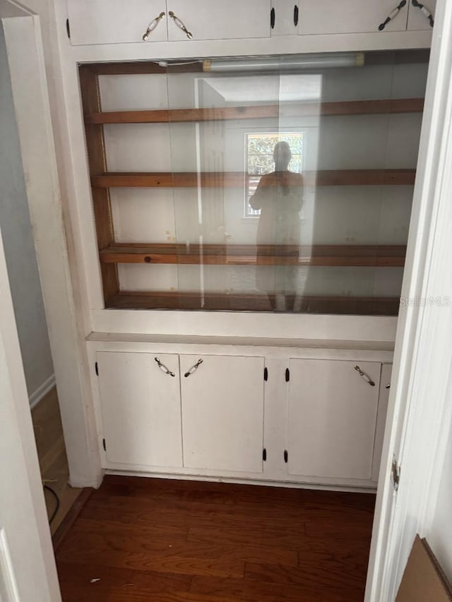 interior space featuring white cabinets and dark wood-type flooring