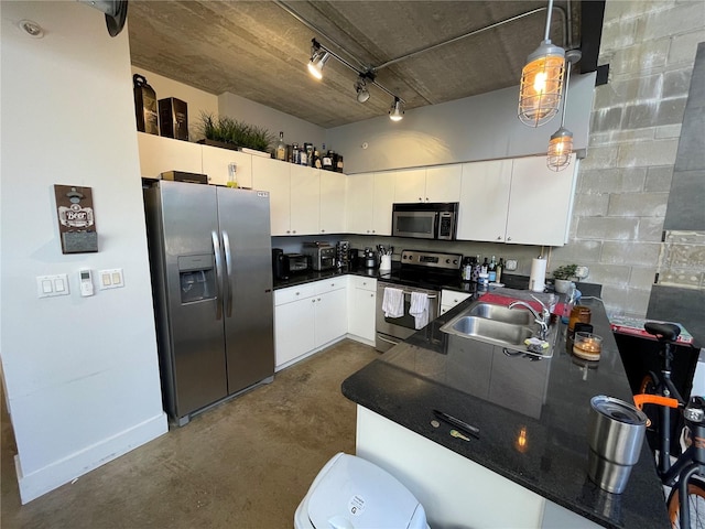 kitchen featuring hanging light fixtures, white cabinetry, sink, and appliances with stainless steel finishes