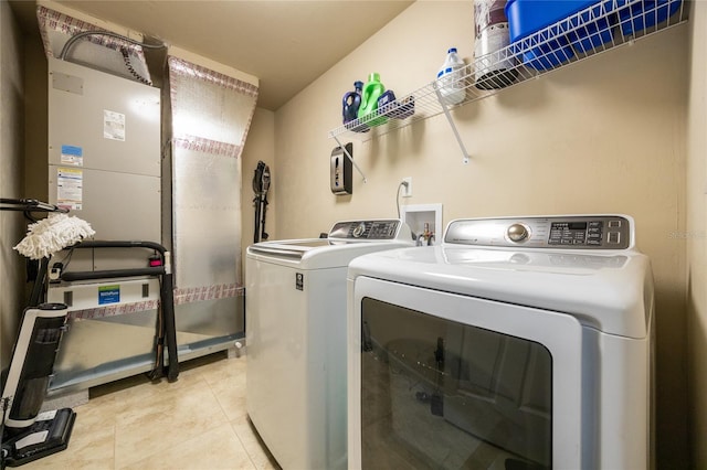 laundry area with light tile patterned floors and separate washer and dryer