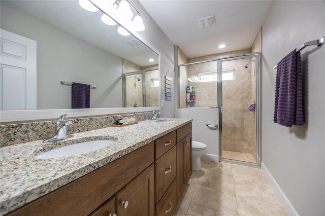 bathroom with tile patterned flooring, vanity, toilet, and a shower with door