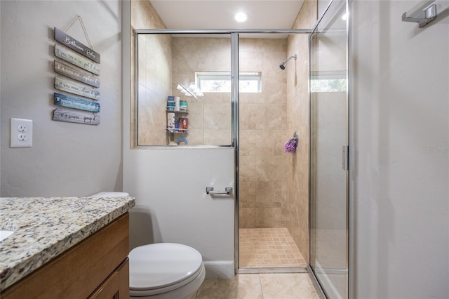 bathroom featuring an enclosed shower, vanity, toilet, and tile patterned floors