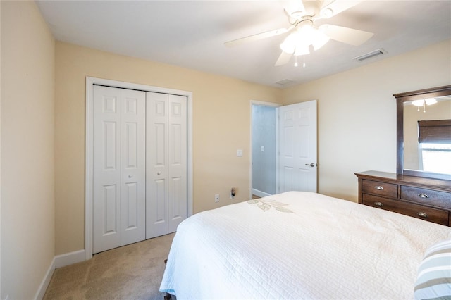 carpeted bedroom featuring ceiling fan and a closet