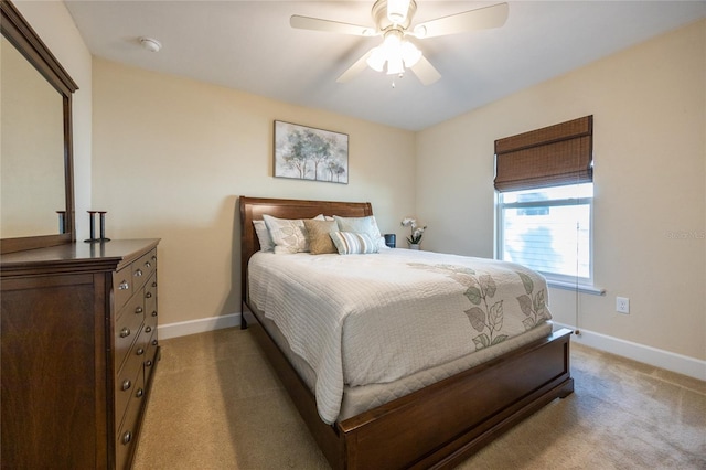 bedroom featuring ceiling fan and light carpet