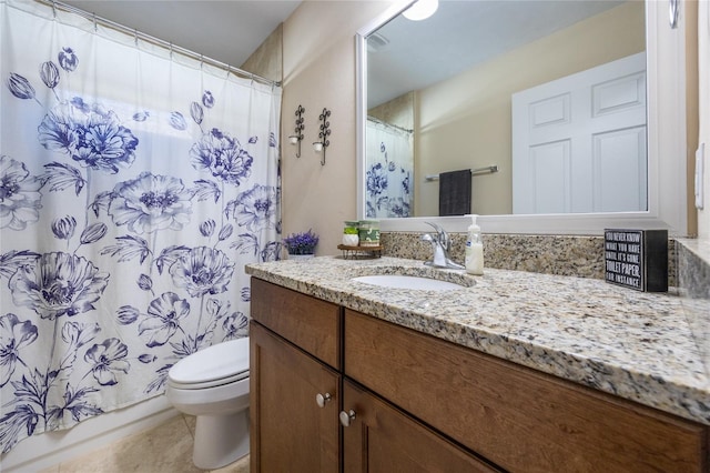 bathroom featuring walk in shower, vanity, and toilet