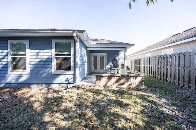 back of property featuring french doors and a patio