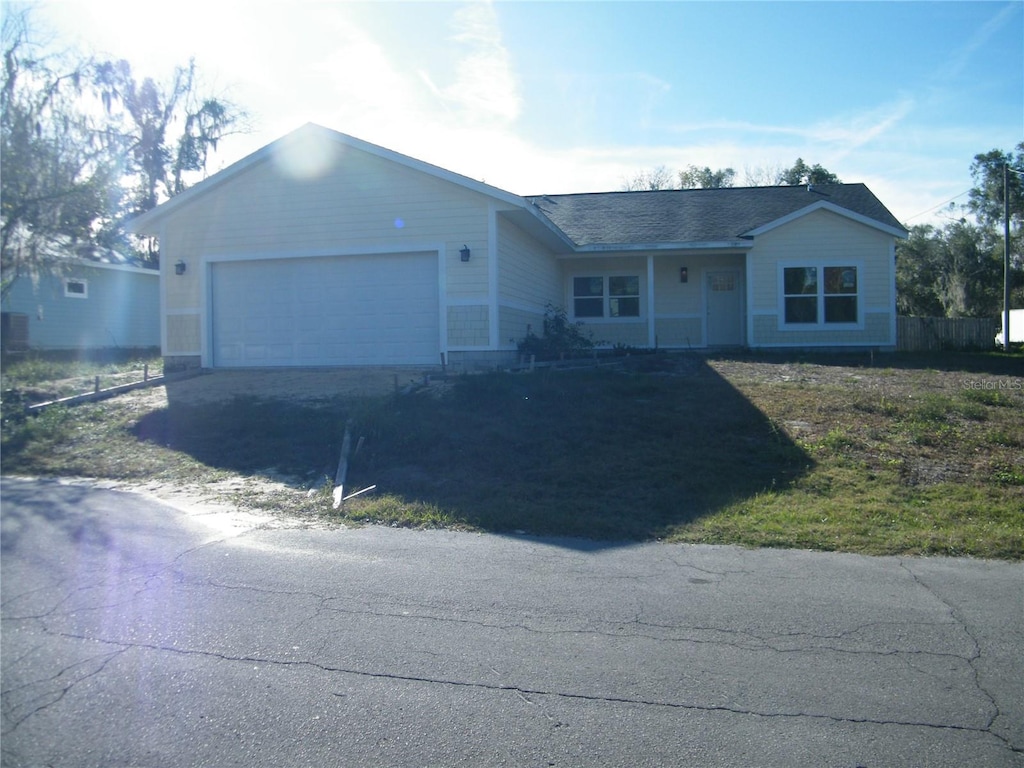 ranch-style house featuring a garage