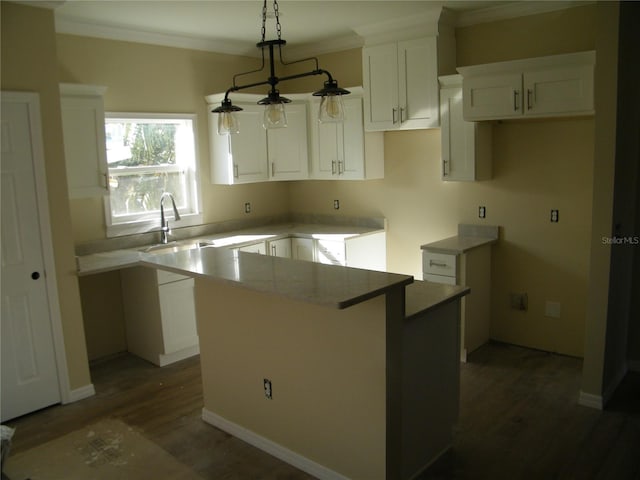 kitchen featuring white cabinets, a kitchen island, and sink