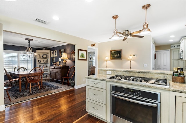 kitchen featuring light stone countertops, pendant lighting, dark hardwood / wood-style flooring, and stainless steel appliances