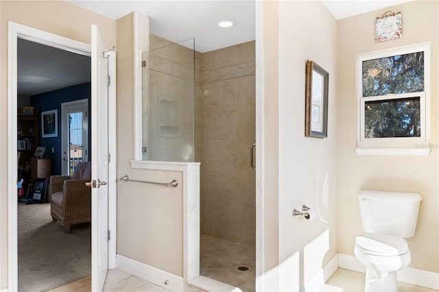 bathroom featuring toilet and an enclosed shower