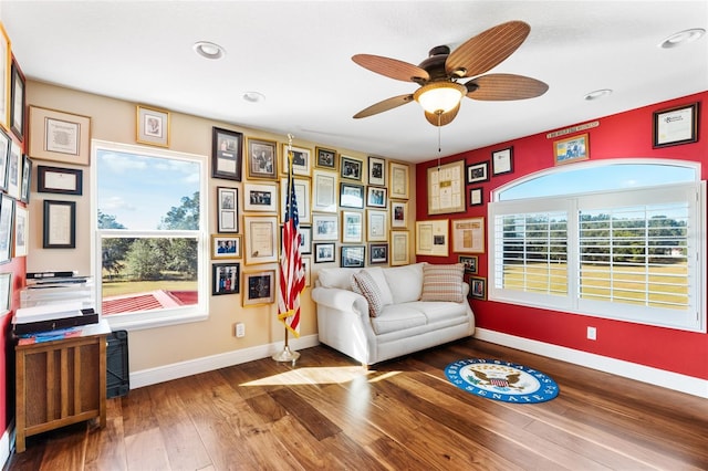 living area featuring ceiling fan and hardwood / wood-style flooring