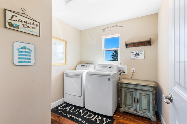 laundry room featuring dark hardwood / wood-style flooring, cabinets, and independent washer and dryer