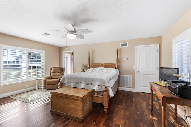 bedroom featuring a textured ceiling, dark hardwood / wood-style floors, and ceiling fan