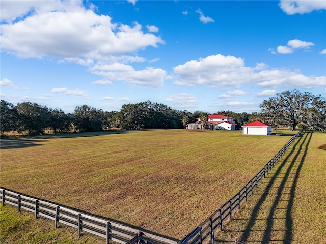 view of yard with a rural view and an outbuilding