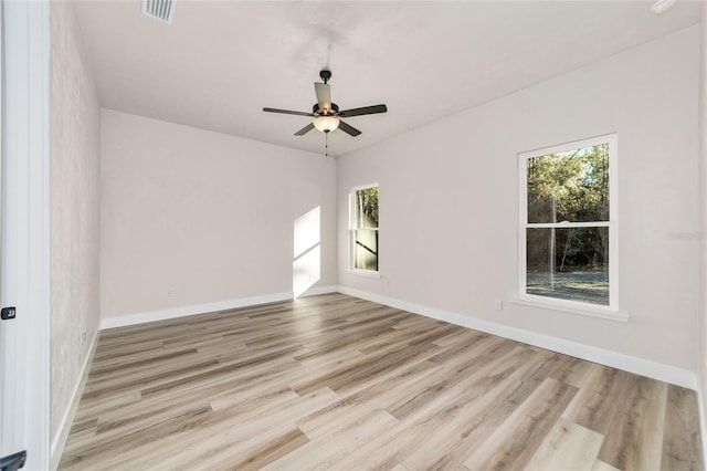 empty room featuring ceiling fan and light hardwood / wood-style floors