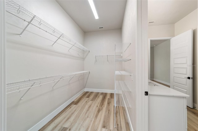 spacious closet with light wood-type flooring