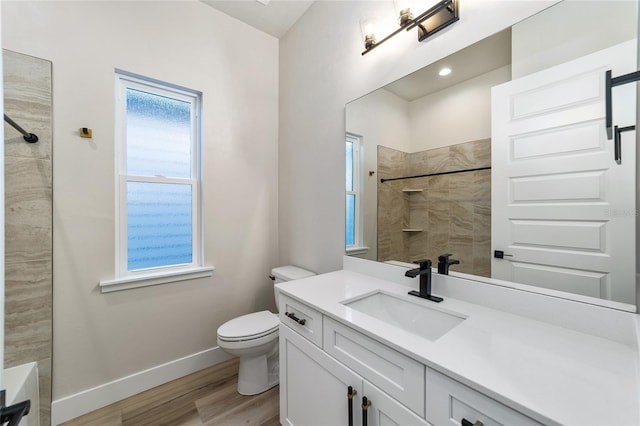 bathroom with hardwood / wood-style floors, vanity, toilet, and plenty of natural light